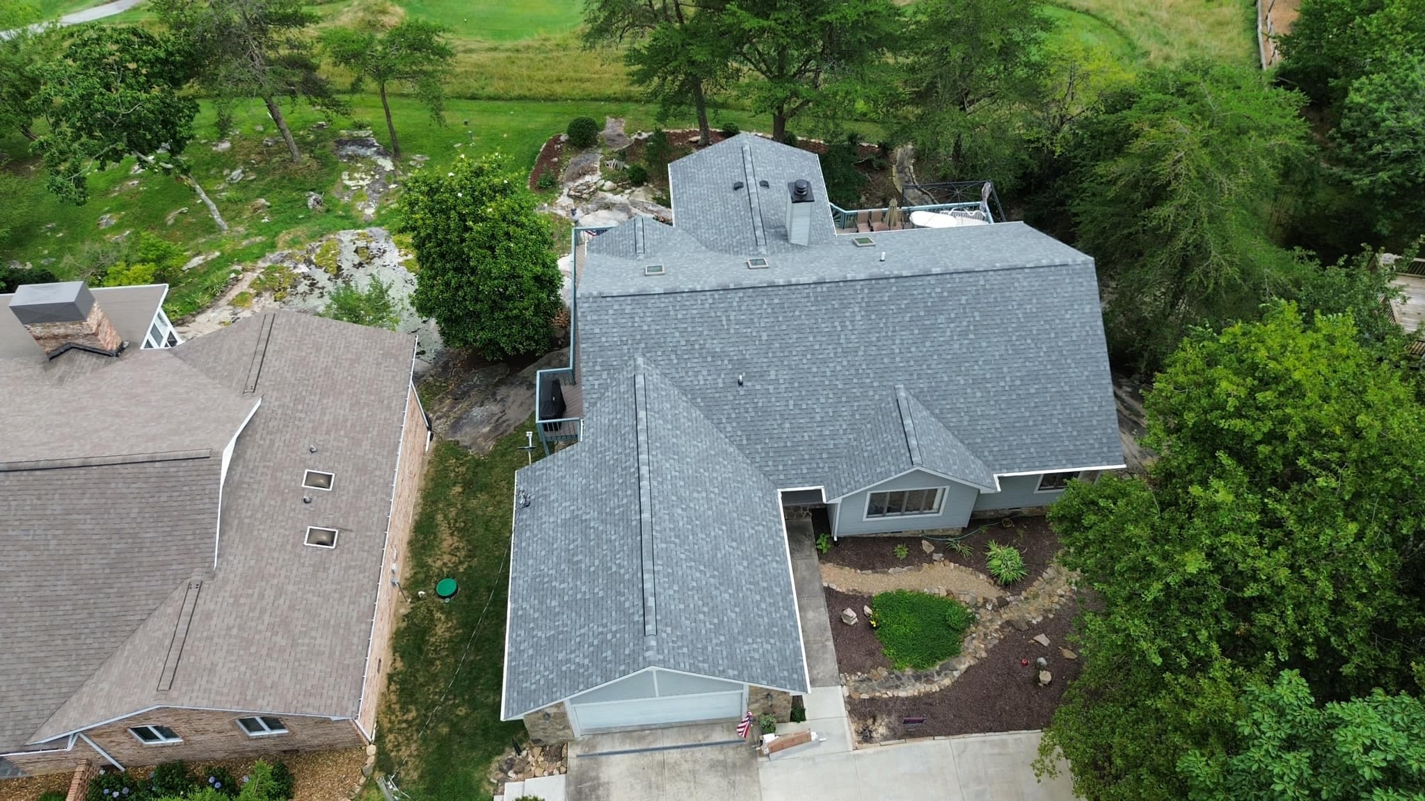 Finished roofing project — aerial view of home with new roof